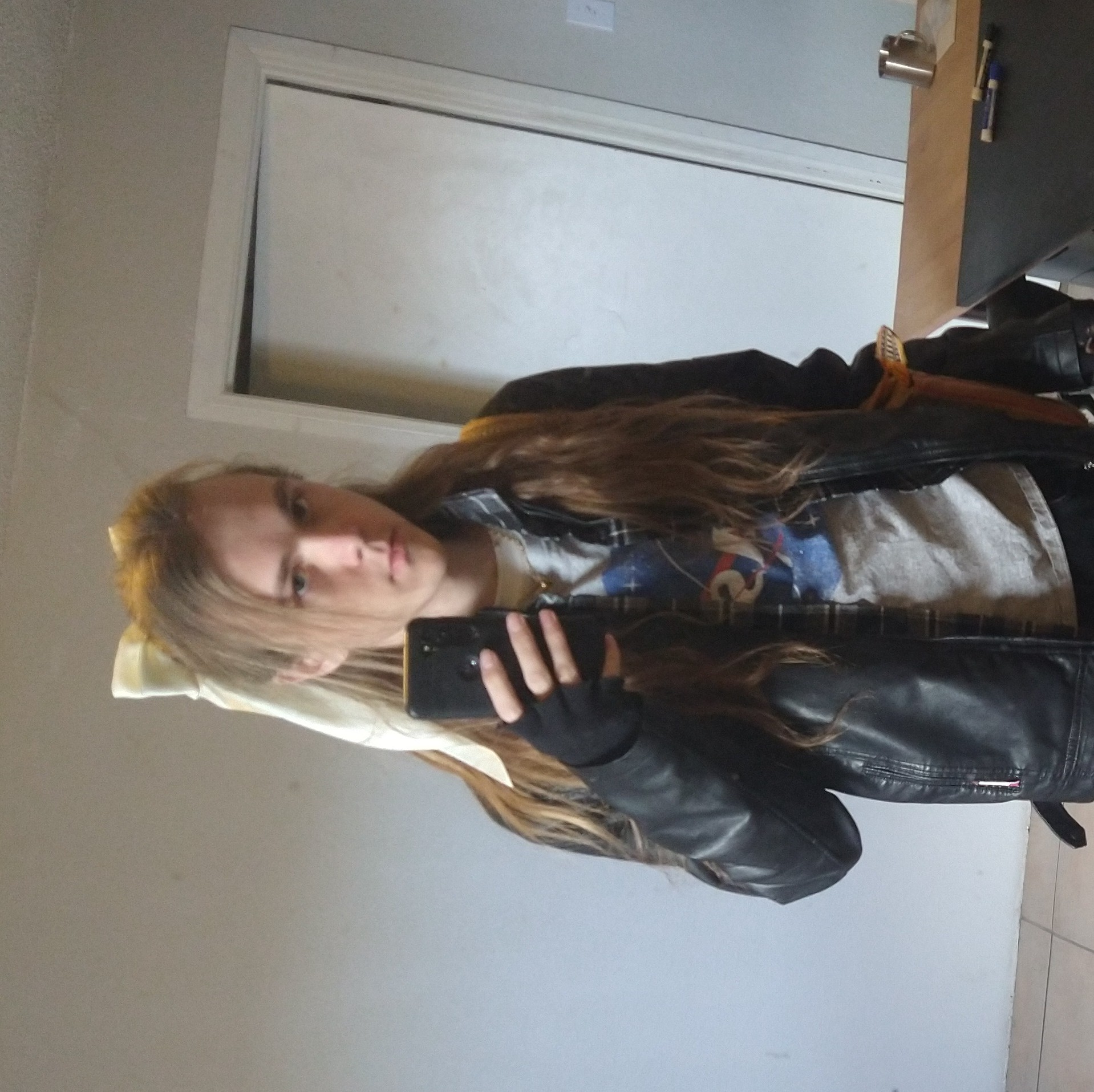 River, wearing a leather jacket and a white hair-bow.